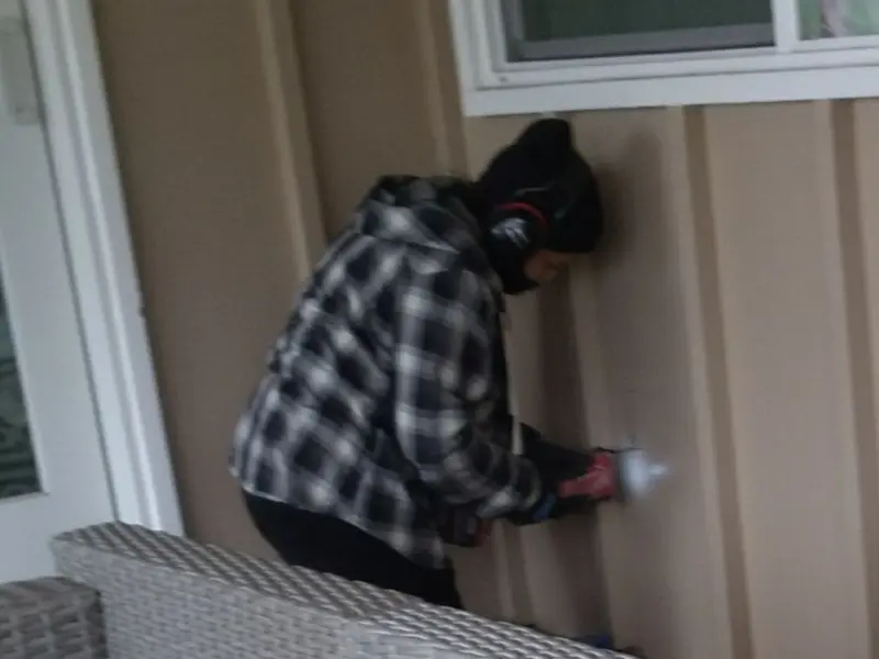 Professional electrician installing an exterior outlet in Homer